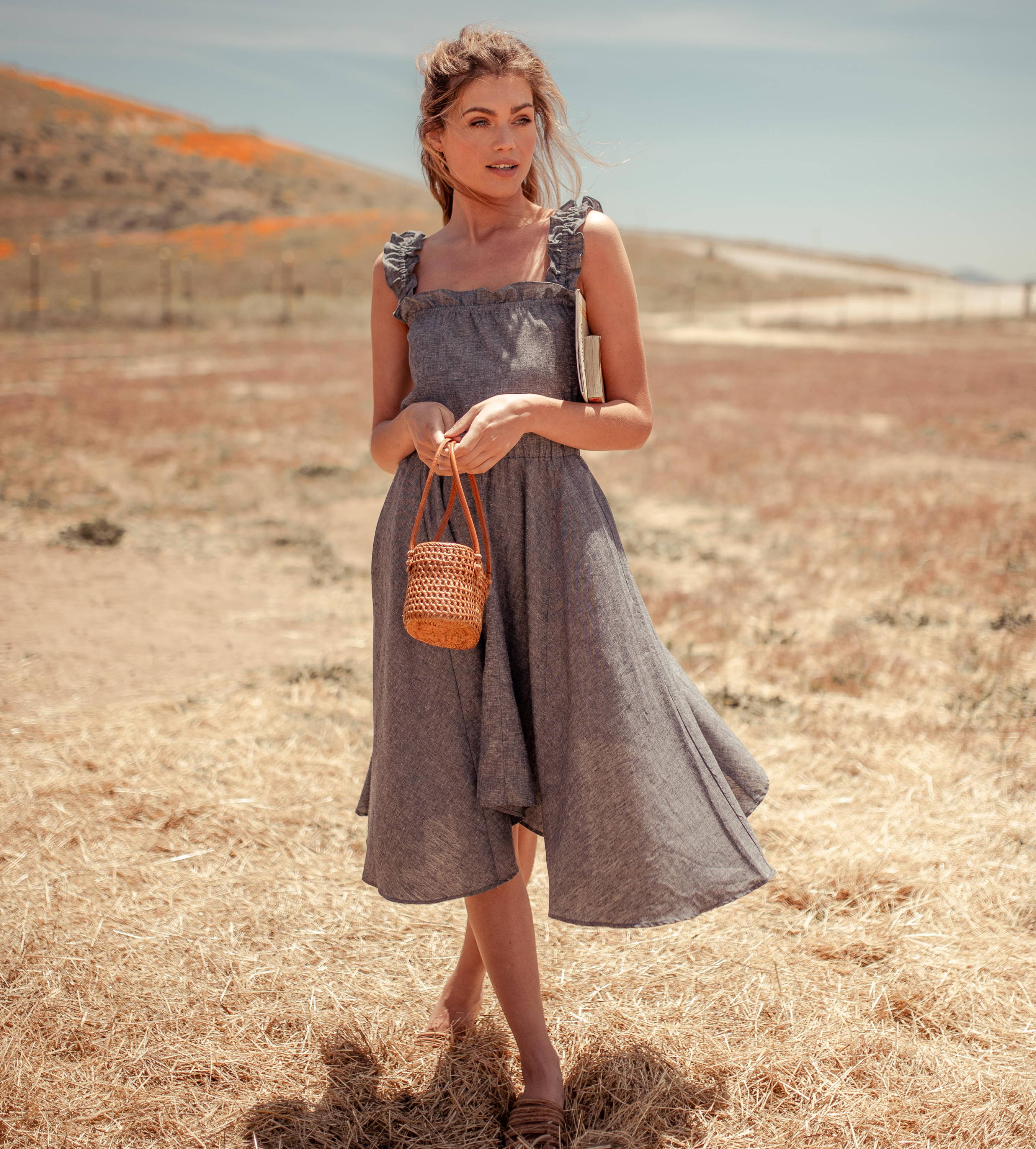 woman wearing grey hemp handkerchief hem dress with ruffles