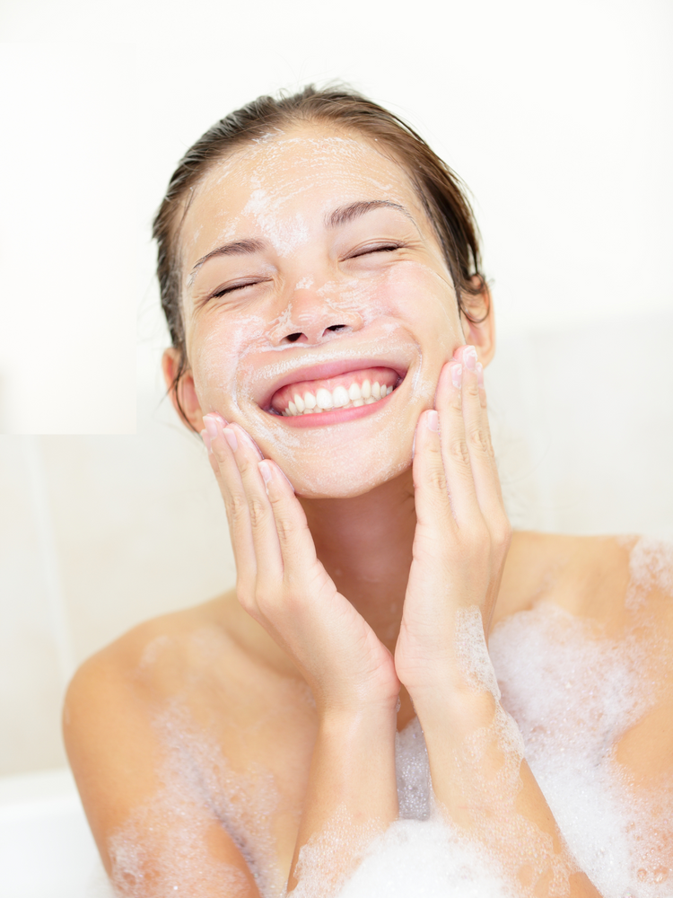 woman washing her face with vegan facial cleansing bar
