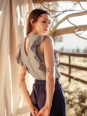 
            
                Load and play video in Gallery viewer, woman wearing grey, sleeveless ruffle hemp top with navy tencel pants
            
        